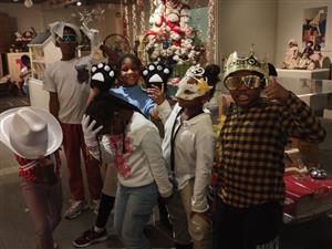 students standing in front of an exhibit dressed in props